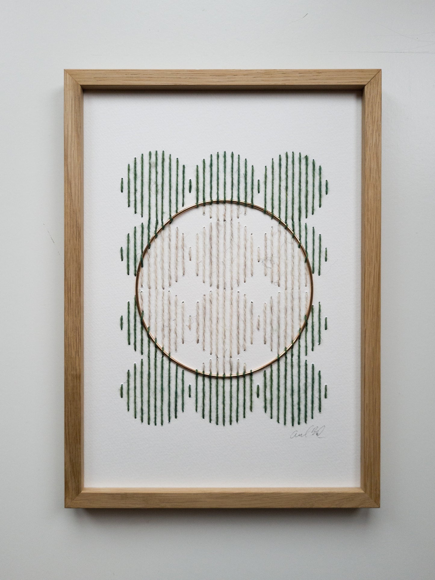 Paper embroidery - green and white with brass ring - front